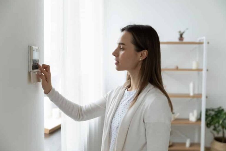 Pleasant young woman using smart home system.